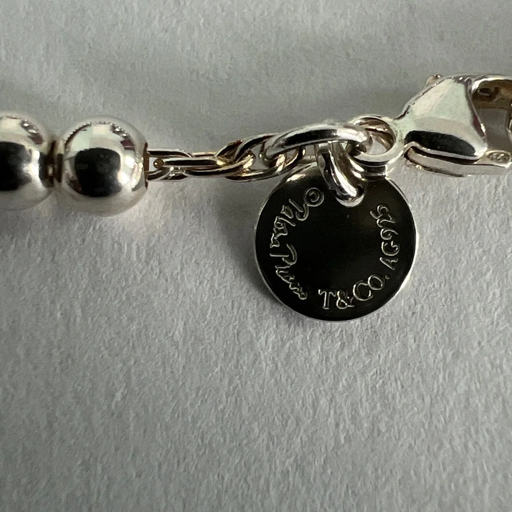 Elegant Silver Beaded Bracelet with Blue Charm